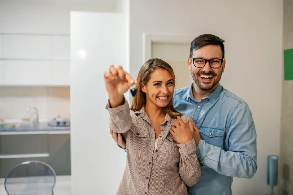First-time buyers holding the keys to their new home