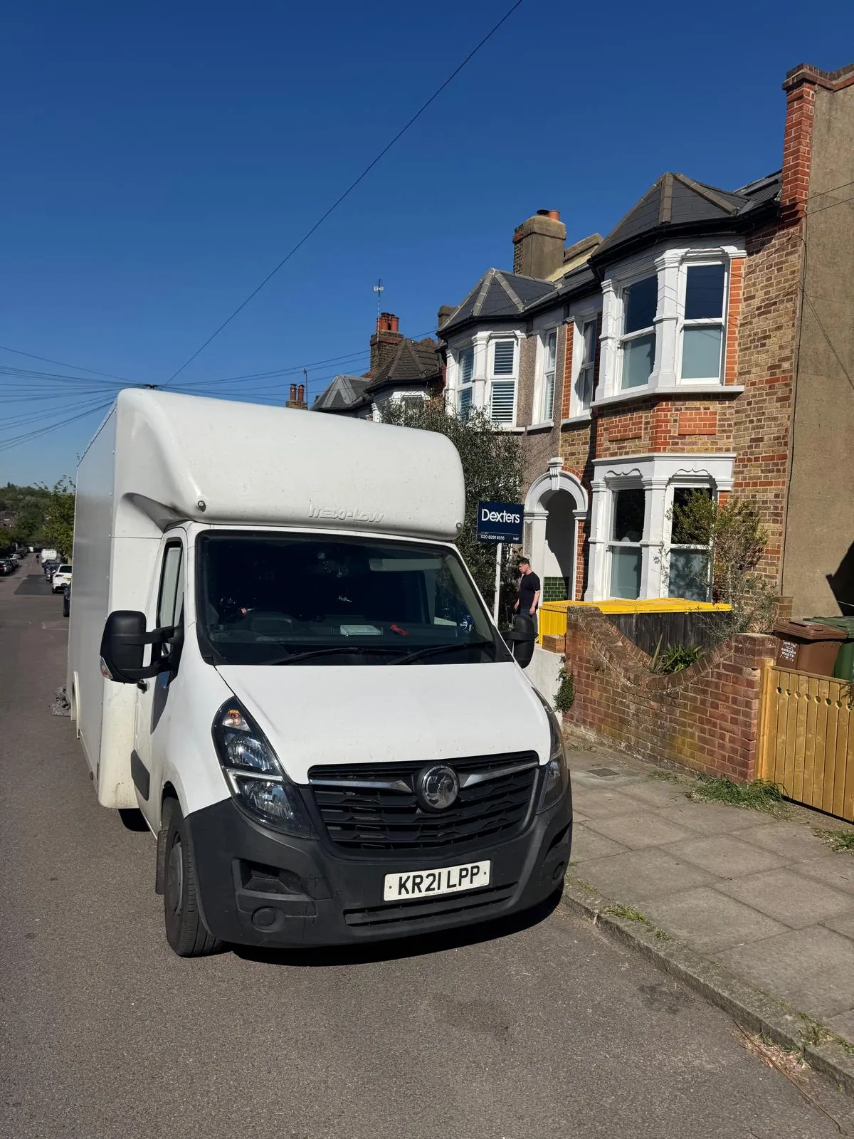 Removal van parked outside a London terraced house