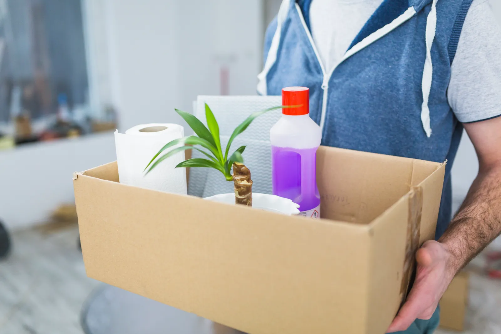 Open box of essentials including kettle, mugs and toilet roll on move day