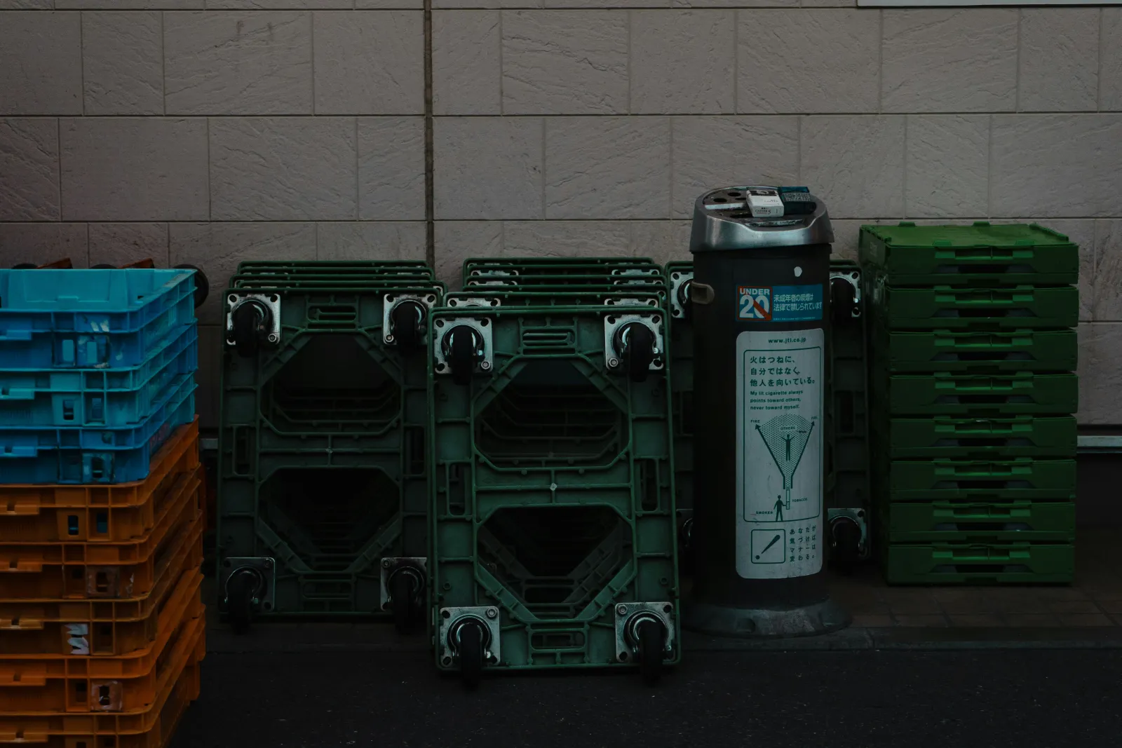 Stack of green reusable plastic moving crates ready for a sustainable house move